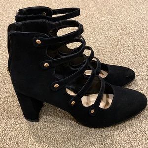 Black strapped heels with gold accents